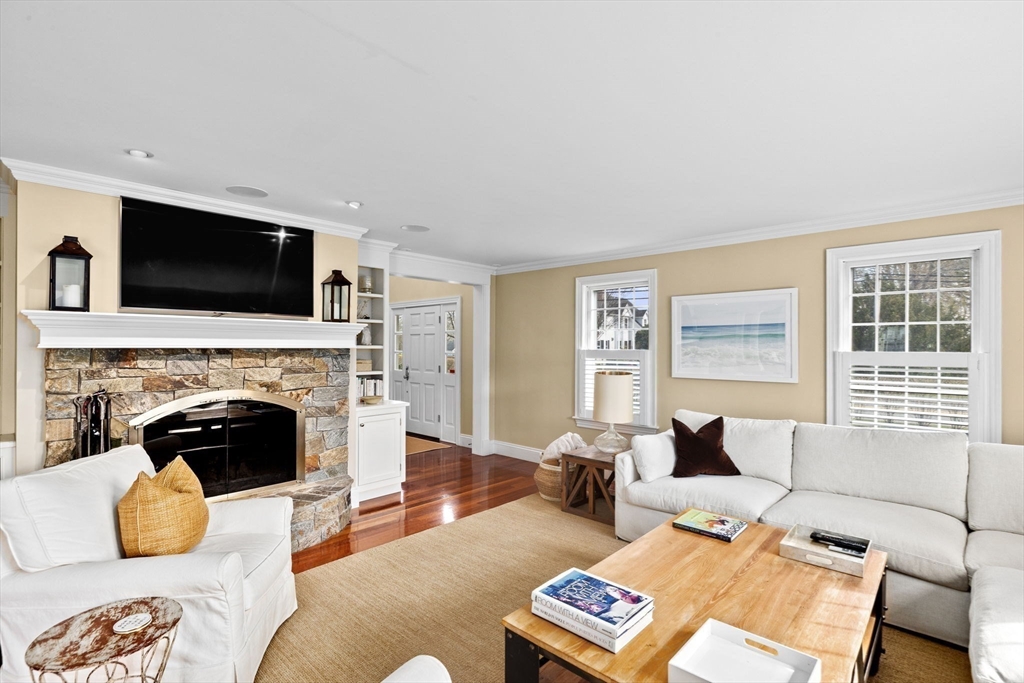 50 Pleasant Street Hingham, MA 02043 - Photo 20 of 41 a living room with furniture a fireplace and a flat screen tv