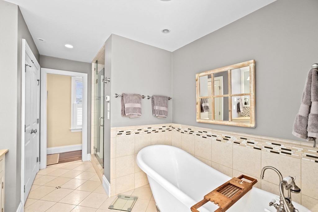 50 Pleasant Street Hingham, MA 02043 - Photo 28 of 41 a bathroom with a tub sink and mirror