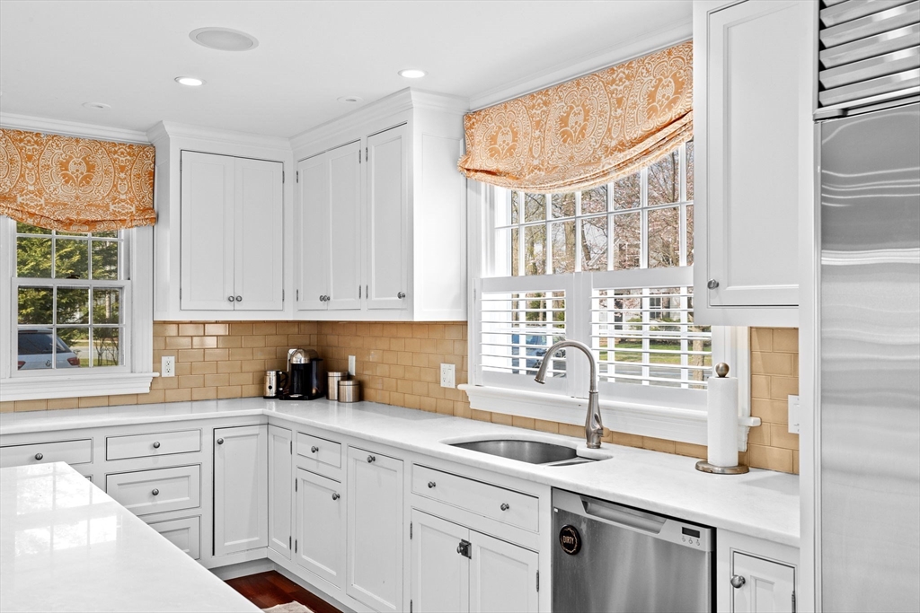 50 Pleasant Street Hingham, MA 02043 - Photo 8 of 41 a kitchen with stainless steel appliances granite countertop a sink a stove and cabinets