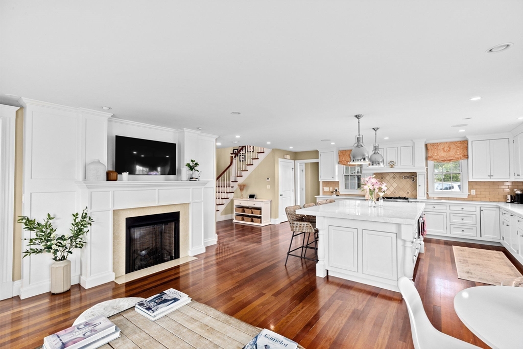 50 Pleasant Street Hingham, MA 02043 - Photo 9 of 41 a living room with stainless steel appliances furniture a fireplace a flat screen tv and a fireplace
