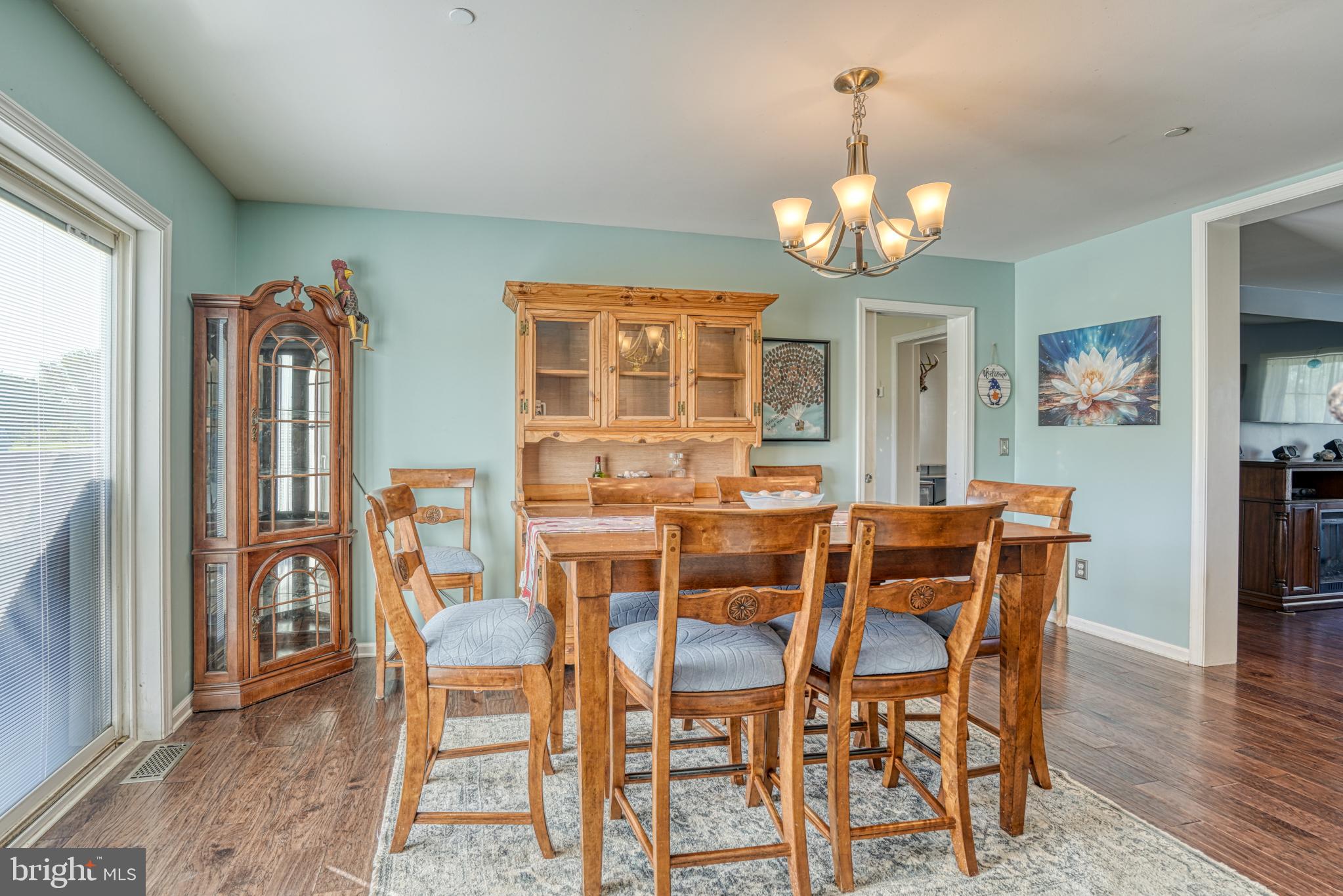 29862 Paddock Lane Easton, MD 21601 - Photo 29 of 83 a view of a dining room with furniture wooden floor and chandelier