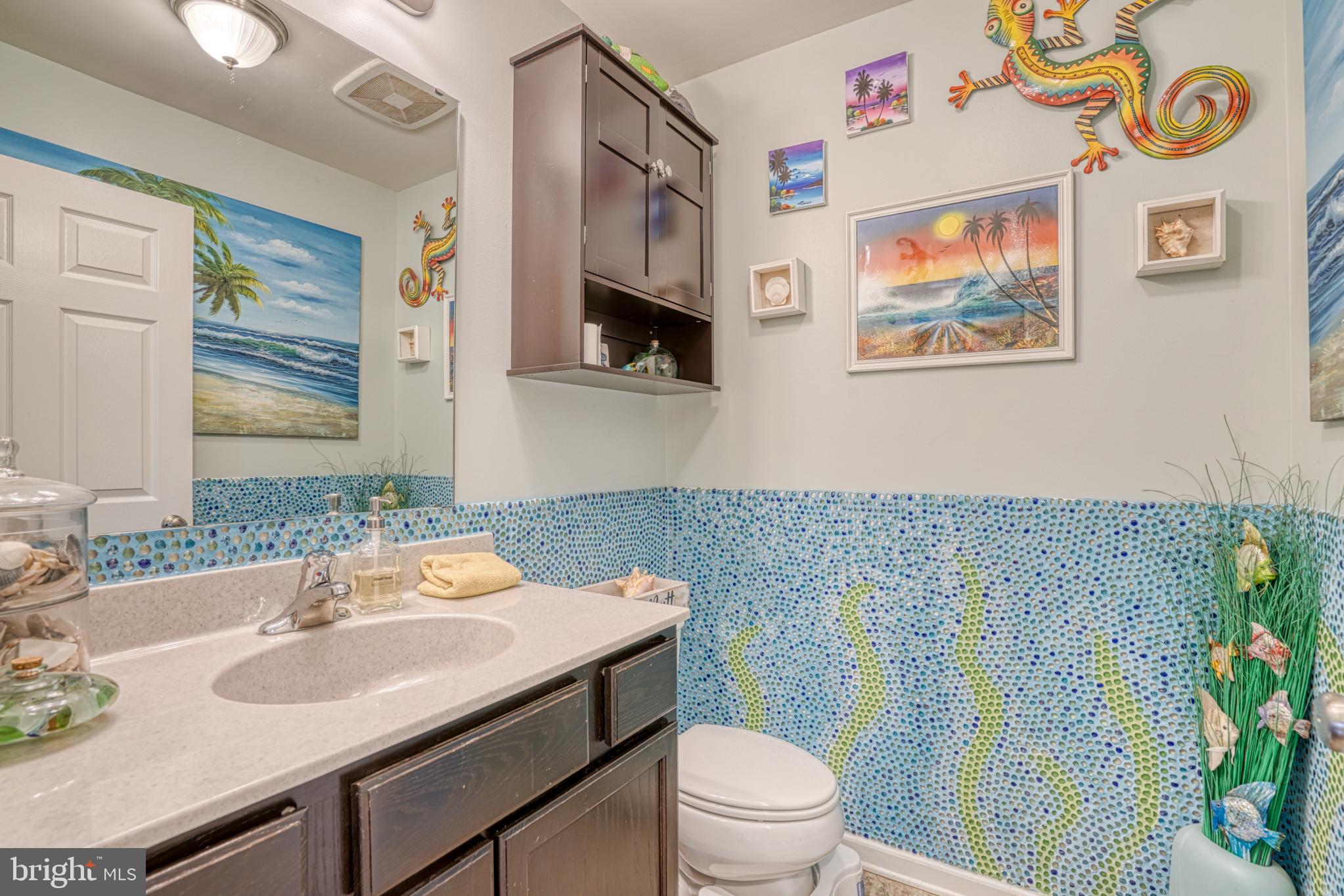 29862 Paddock Lane Easton, MD 21601 - Photo 35 of 83 a bathroom with a sink a toilet and a mirror