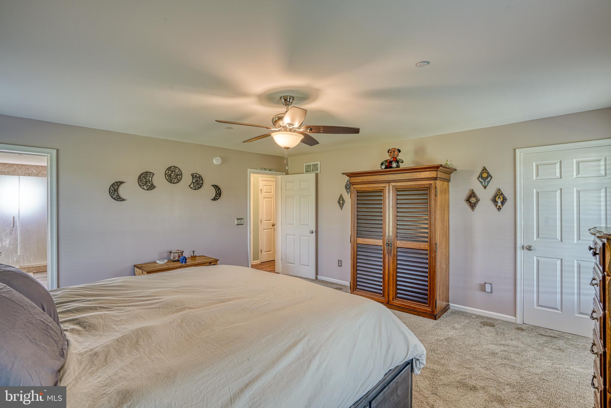 29862 Paddock Lane Easton, MD 21601 - Photo 36 of 83 a bedroom with a bed and a chandelier