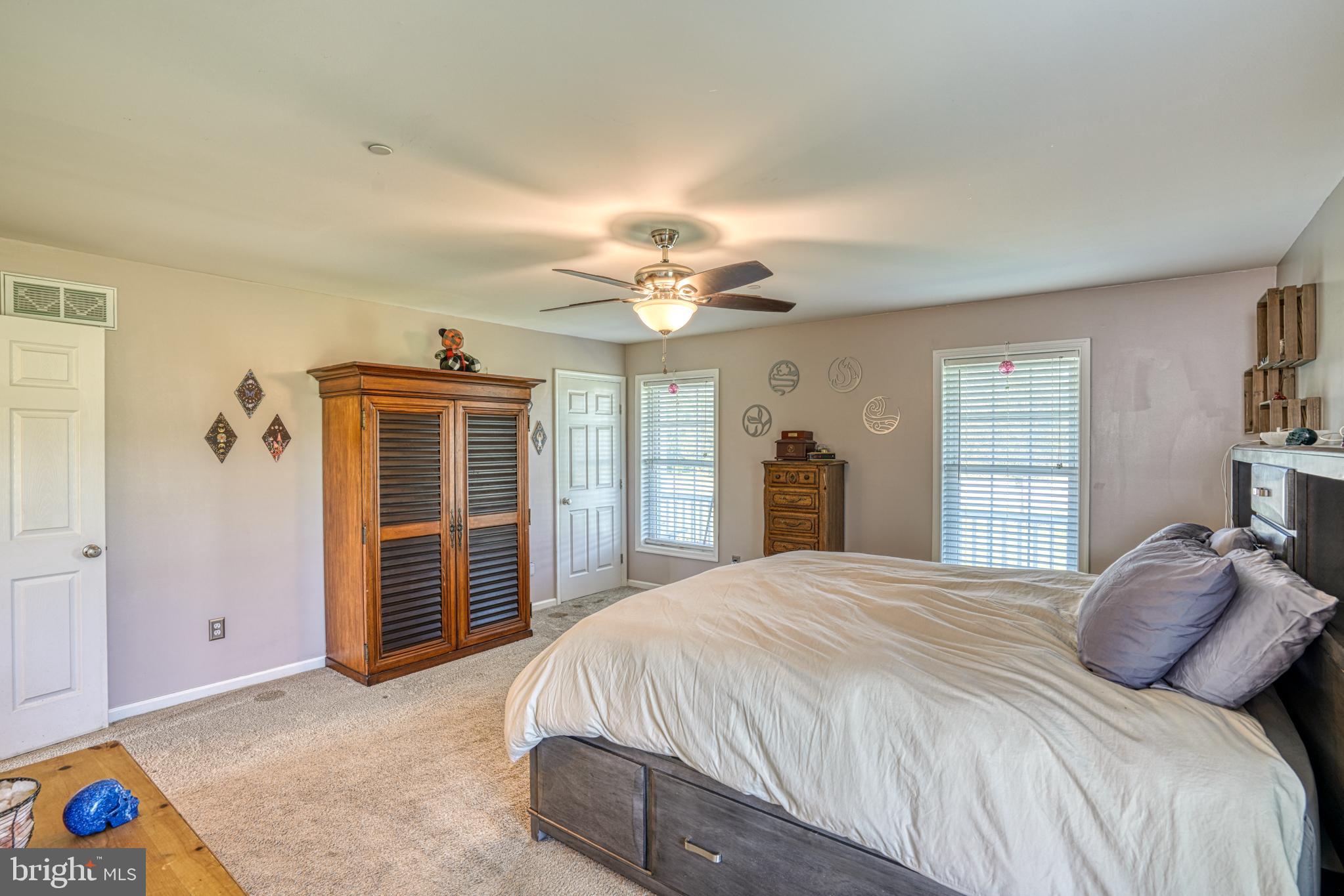 29862 Paddock Lane Easton, MD 21601 - Photo 39 of 83 a bedroom with a bed and a chandelier