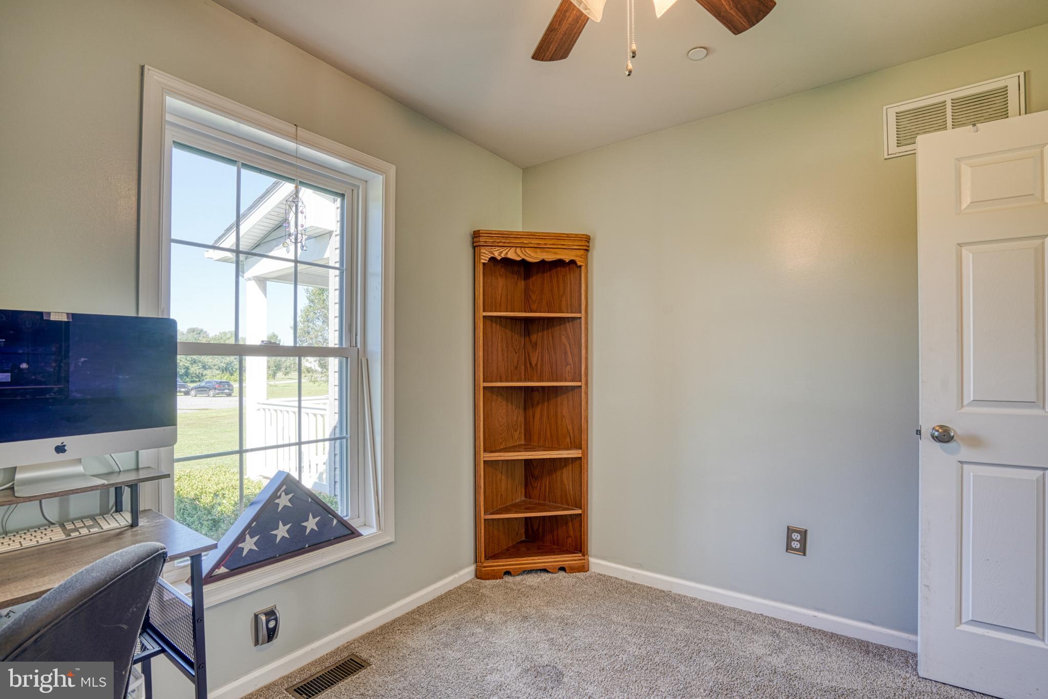 29862 Paddock Lane Easton, MD 21601 - Photo 46 of 83 a living room with a window and a dresser