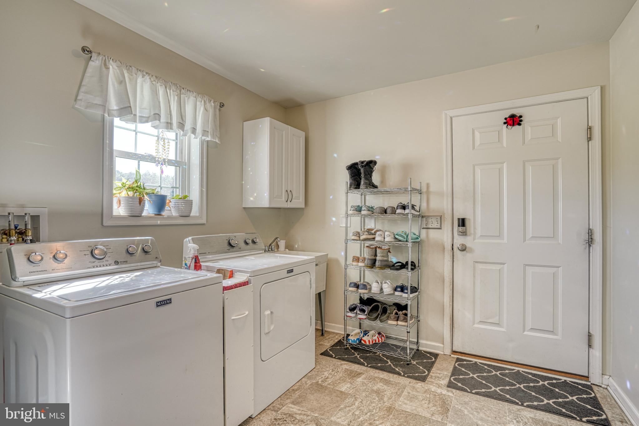 29862 Paddock Lane Easton, MD 21601 - Photo 49 of 83 a view of utility room with closet dryer and washer