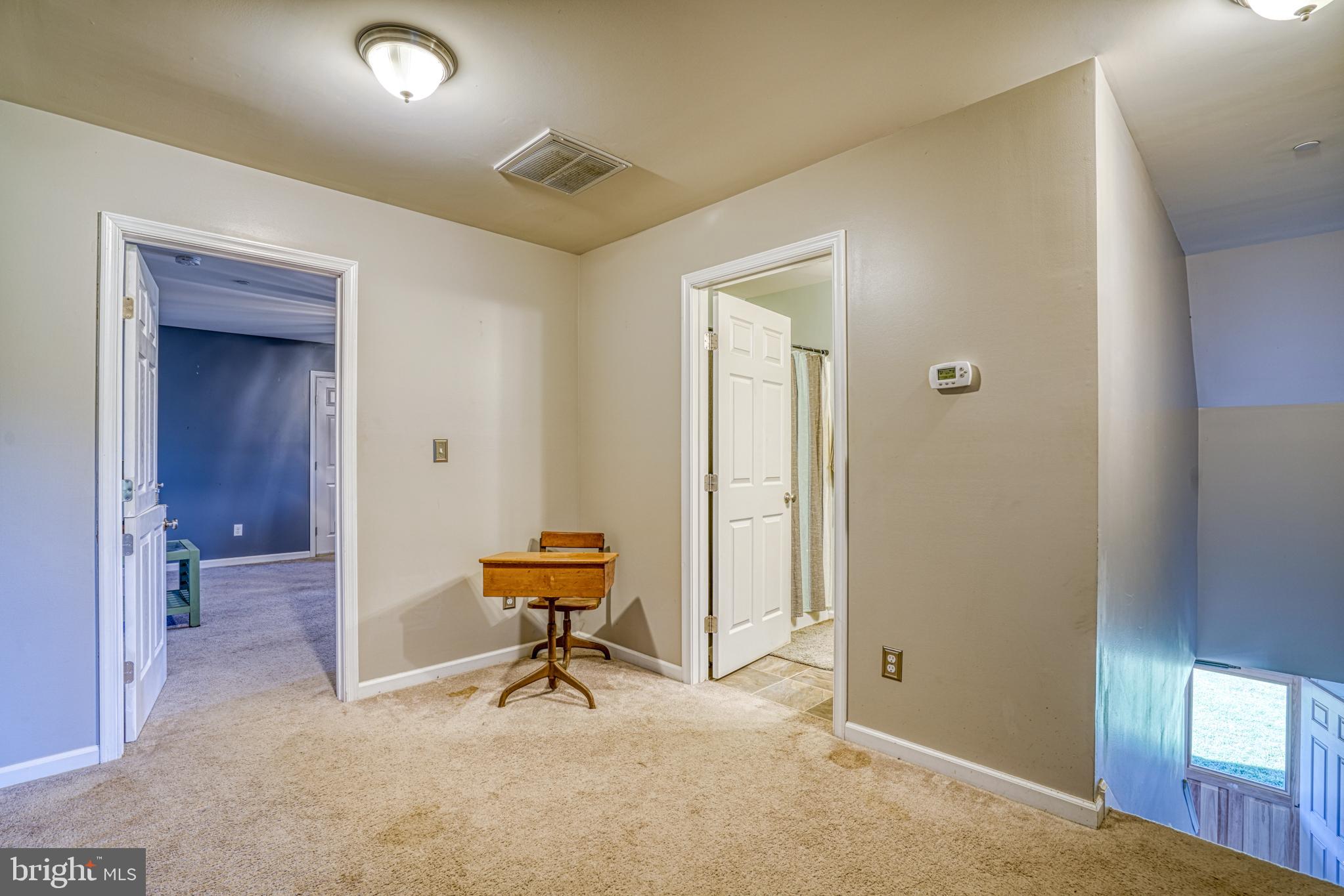 29862 Paddock Lane Easton, MD 21601 - Photo 52 of 83 a view of a hallway with chairs and a table in a room