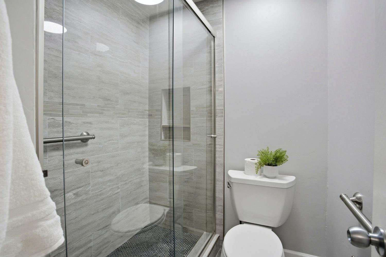 11150 Trinity River Drive, Unit 124 Rancho Cordova, CA 95670 - Photo 17 of 29 Master bath with tile flooring, tile surrounding shower wall, and grab bar!
