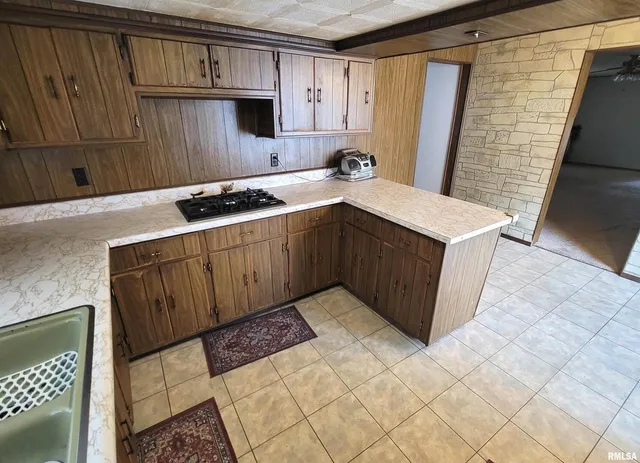 a kitchen with a sink stove and cabinets