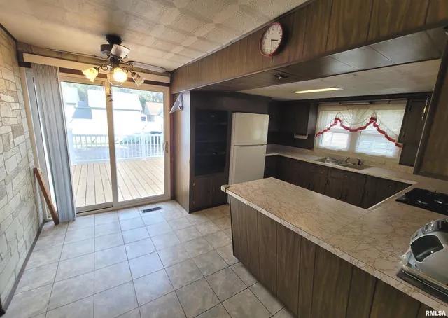 a kitchen with stainless steel appliances a stove a sink and a microwave