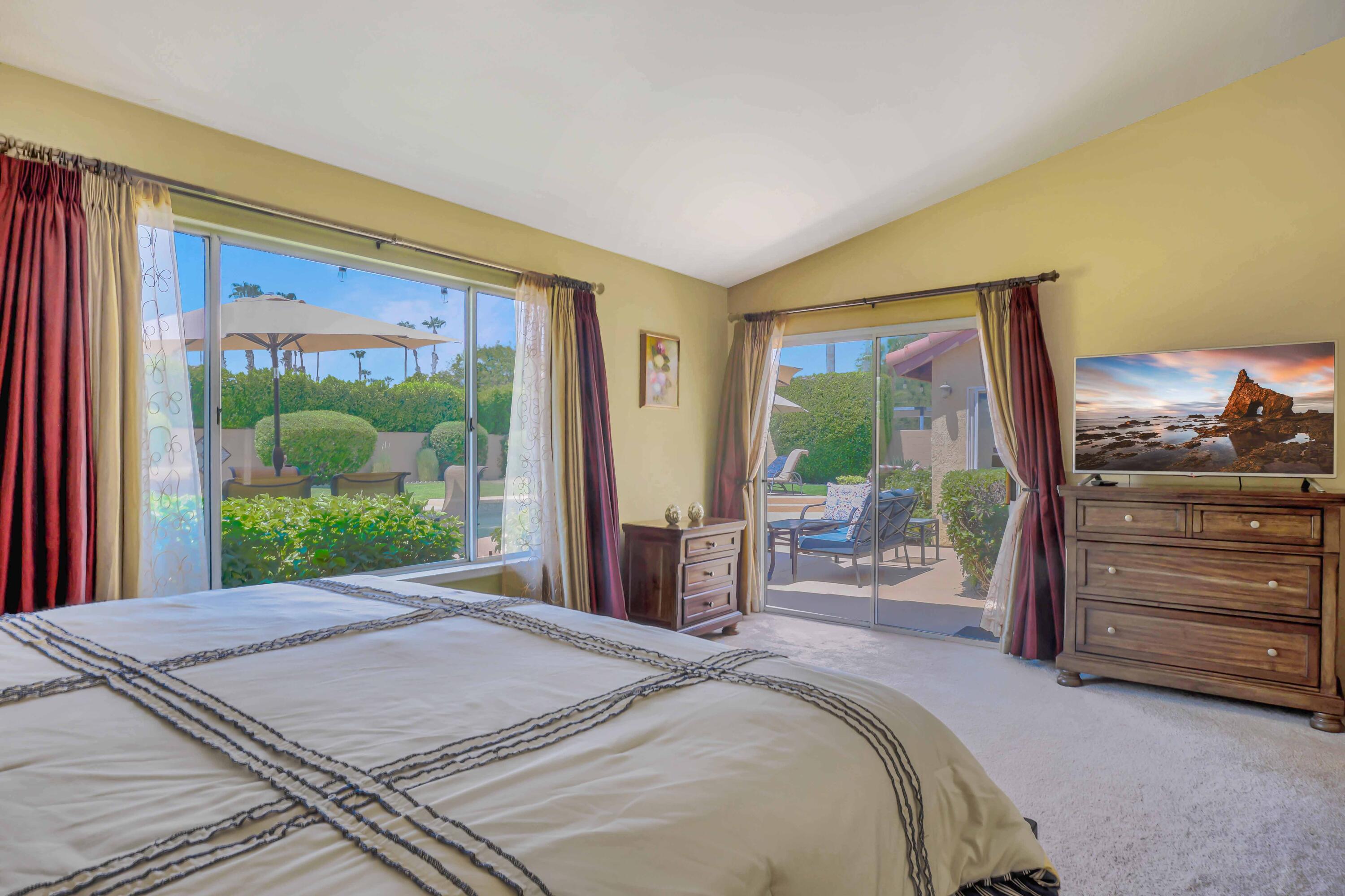 39795 Regency Way Palm Desert, CA 92211 - Photo 12 of 25 a bed sitting in a spacious bedroom next to a window