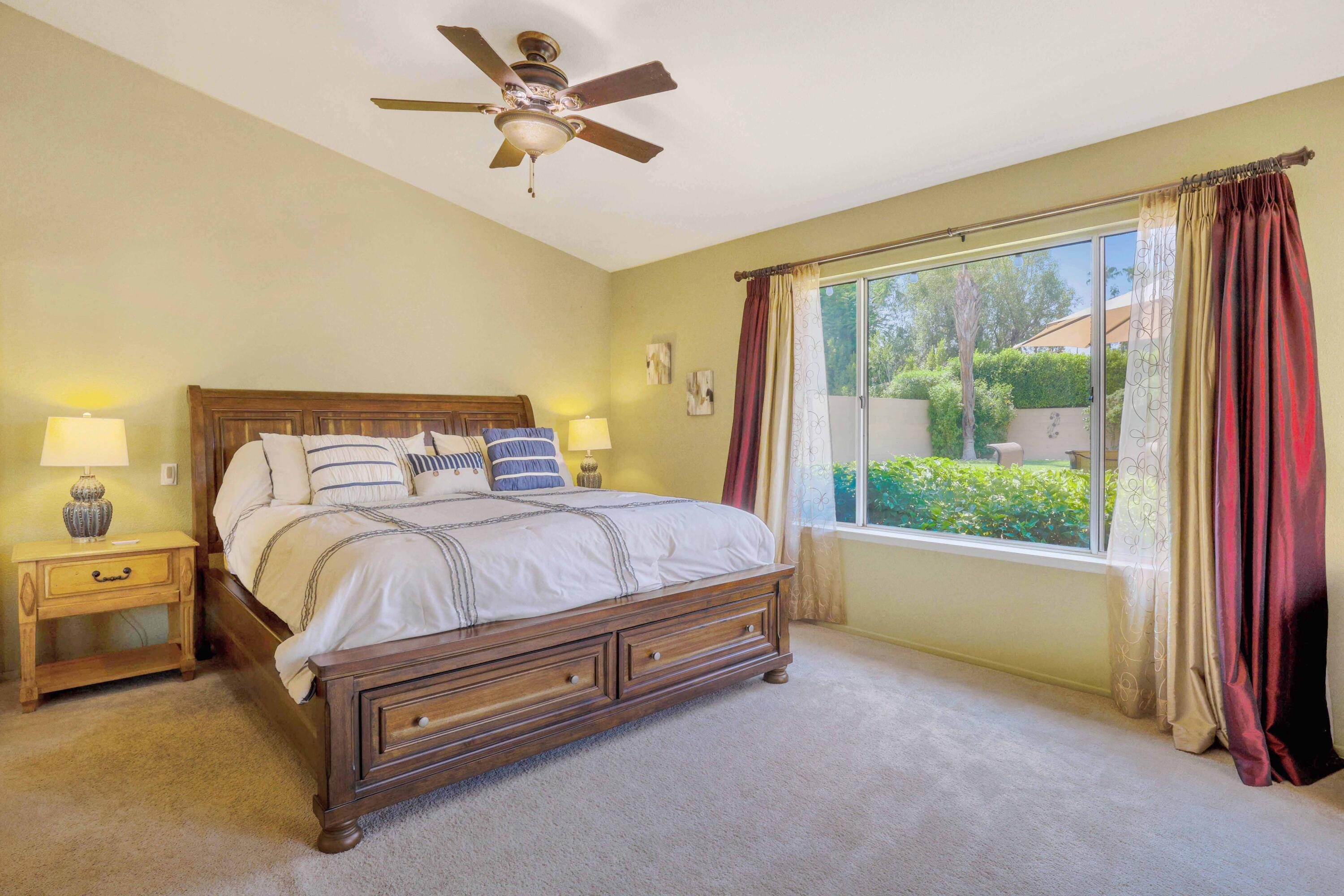 39795 Regency Way Palm Desert, CA 92211 - Photo 13 of 25 a spacious bedroom with a bed and a large window