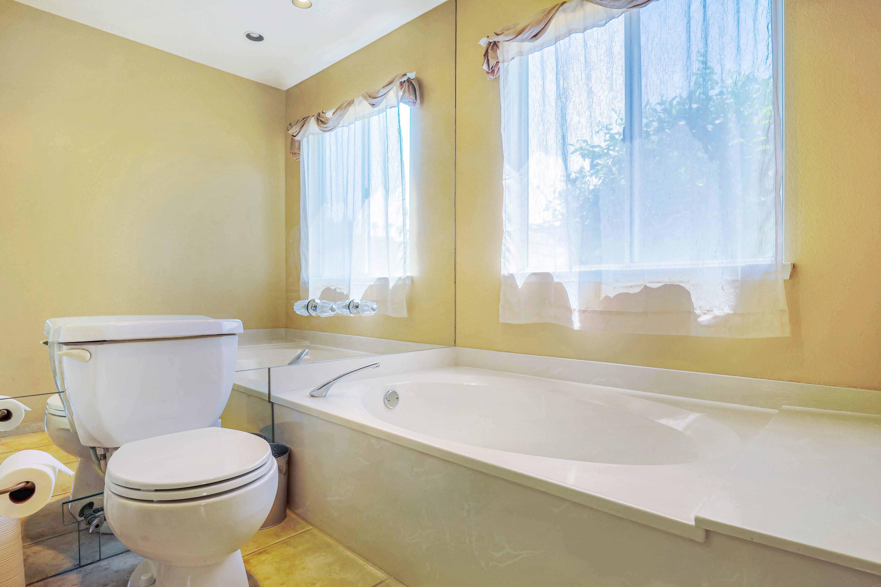 39795 Regency Way Palm Desert, CA 92211 - Photo 15 of 25 a white toilet sitting next to a bath tub