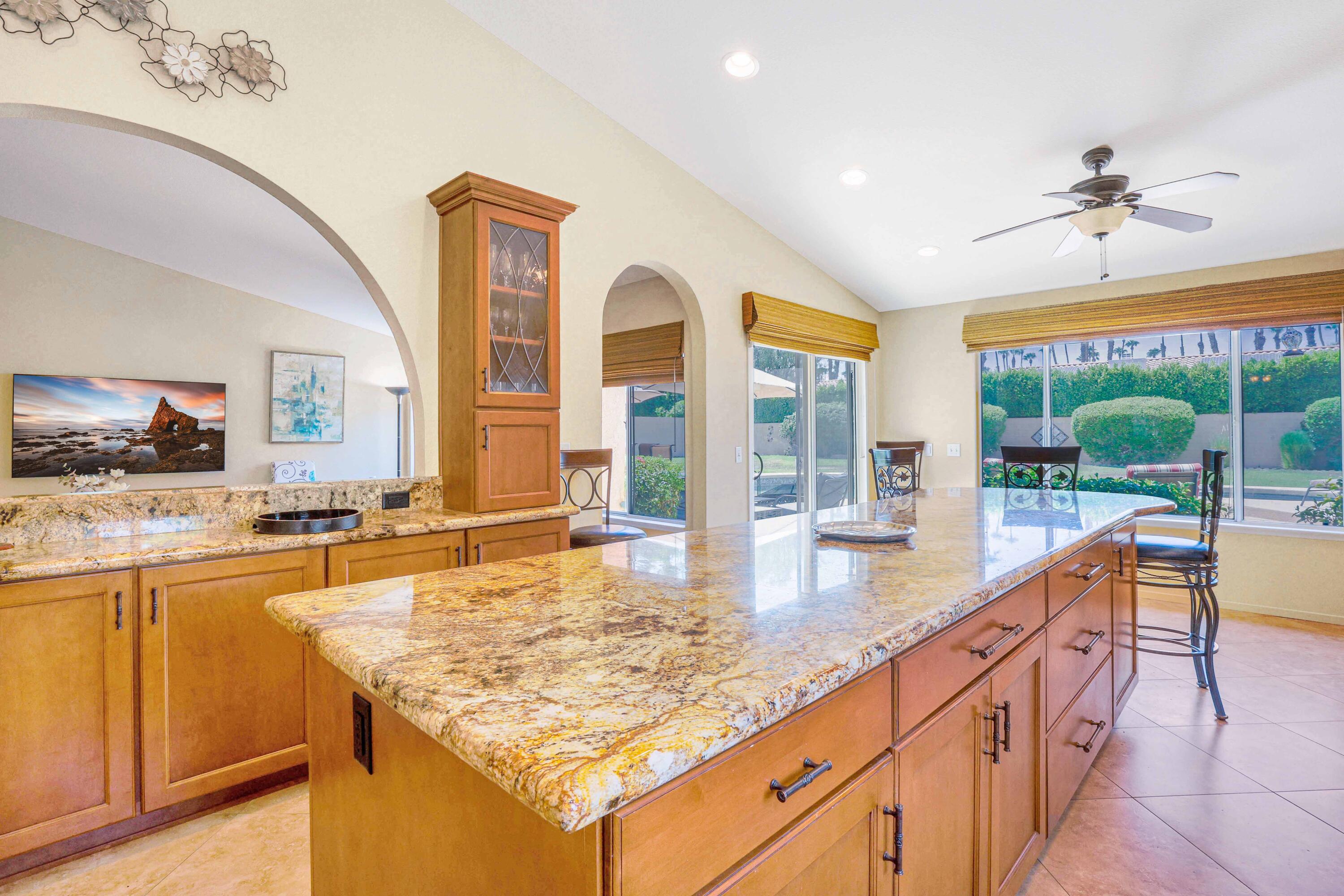 39795 Regency Way Palm Desert, CA 92211 - Photo 3 of 25 a dining hall with stainless steel appliances granite countertop a sink and dishwasher