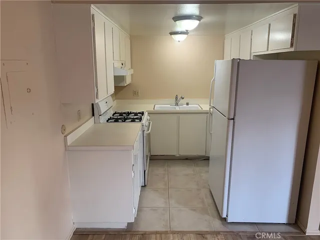 a utility room with cabinets washer and dryer