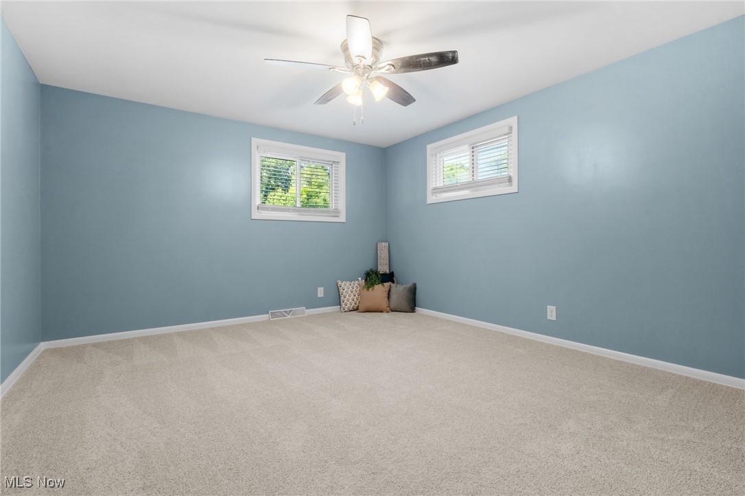 4895 3rd Street Northwest Canton, OH 44708 - Photo 13 of 27 Carpeted empty room with baseboards and a ceiling fan