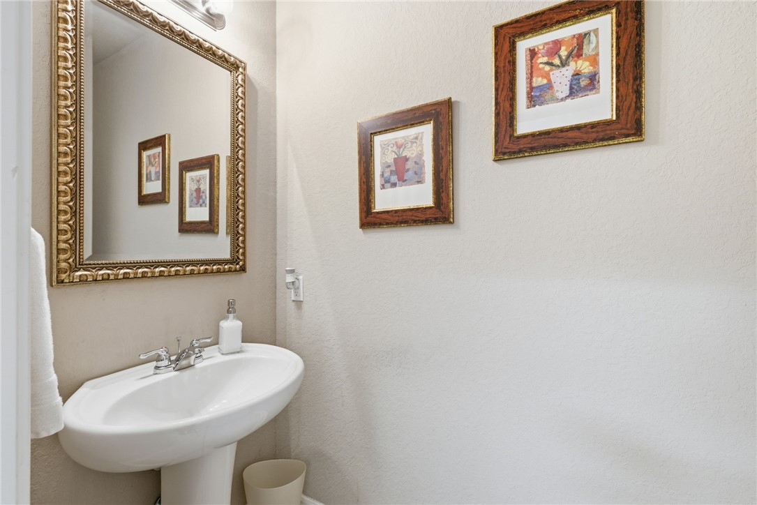 8826 Virginia Rye San Antonio, TX 78254 - Photo 19 of 40 a bathroom with a sink and a mirror
