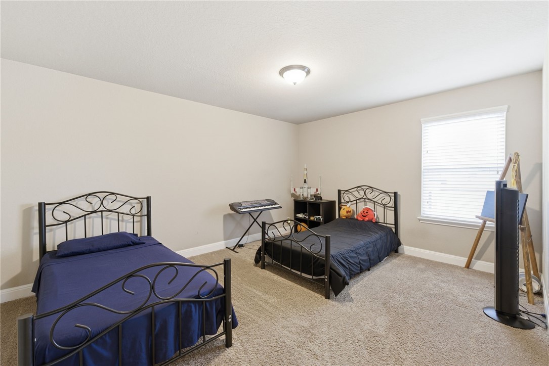 8826 Virginia Rye San Antonio, TX 78254 - Photo 23 of 40 a bedroom with furniture and a window