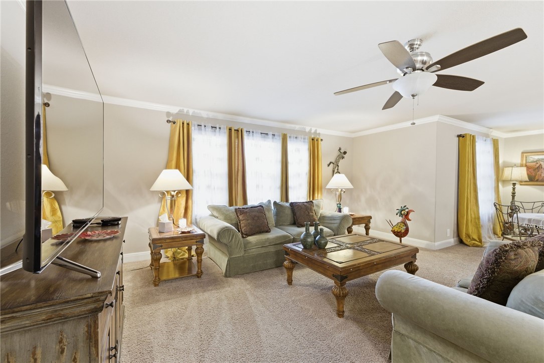 8826 Virginia Rye San Antonio, TX 78254 - Photo 28 of 40 a living room with furniture ceiling fan and a large window