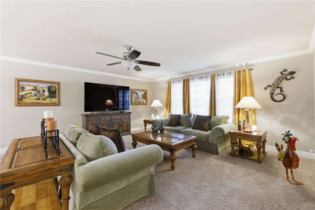 8826 Virginia Rye San Antonio, TX 78254 - Photo 29 of 40 a living room with furniture and a flat screen tv