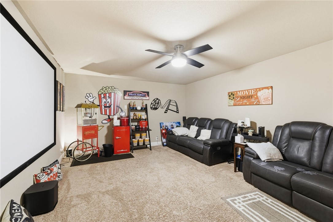 8826 Virginia Rye San Antonio, TX 78254 - Photo 32 of 40 a living room with furniture a ceiling fan and a rug