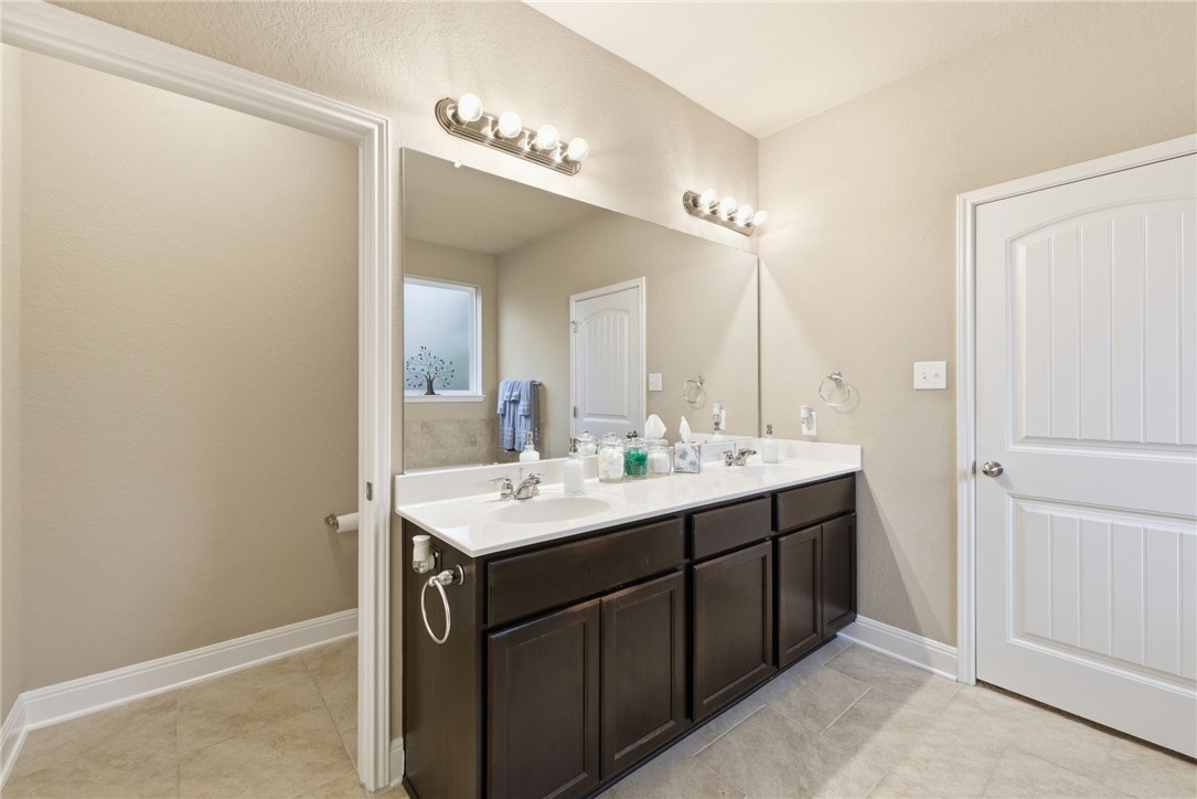 8826 Virginia Rye San Antonio, TX 78254 - Photo 35 of 40 a bathroom with a sink and a mirror