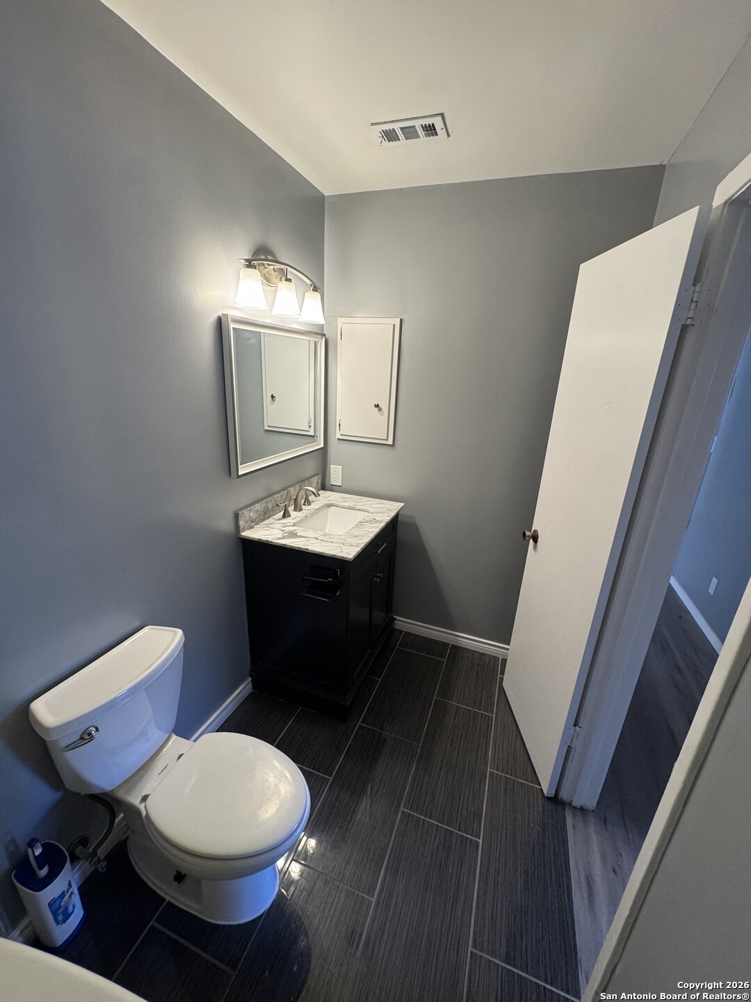 5019 Concord Ridge San Antonio, TX 78228 - Photo 14 of 19 a bathroom with a toilet sink and mirror