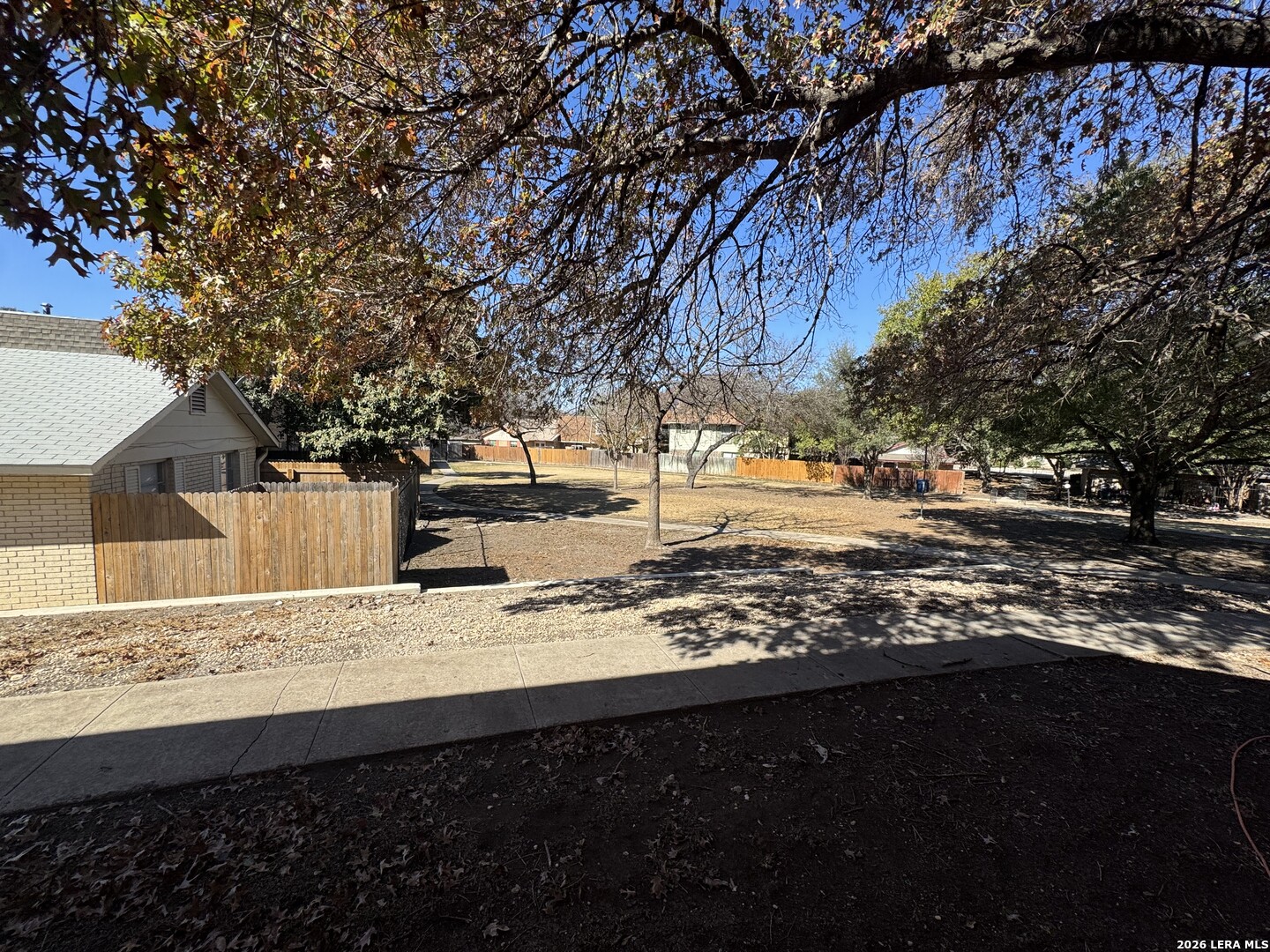 5019 Concord Ridge San Antonio, TX 78228 - Photo 16 of 19 a view of a yard with wooden fence