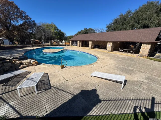a view of a roof deck with couches and wooden floor