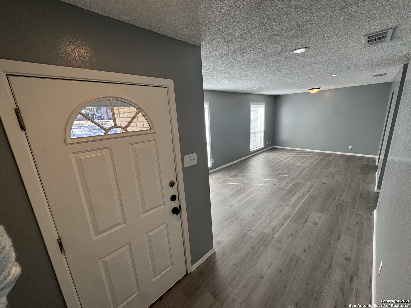 5019 Concord Ridge San Antonio, TX 78228 - Photo 2 of 19 wooden floor in an empty room with a window