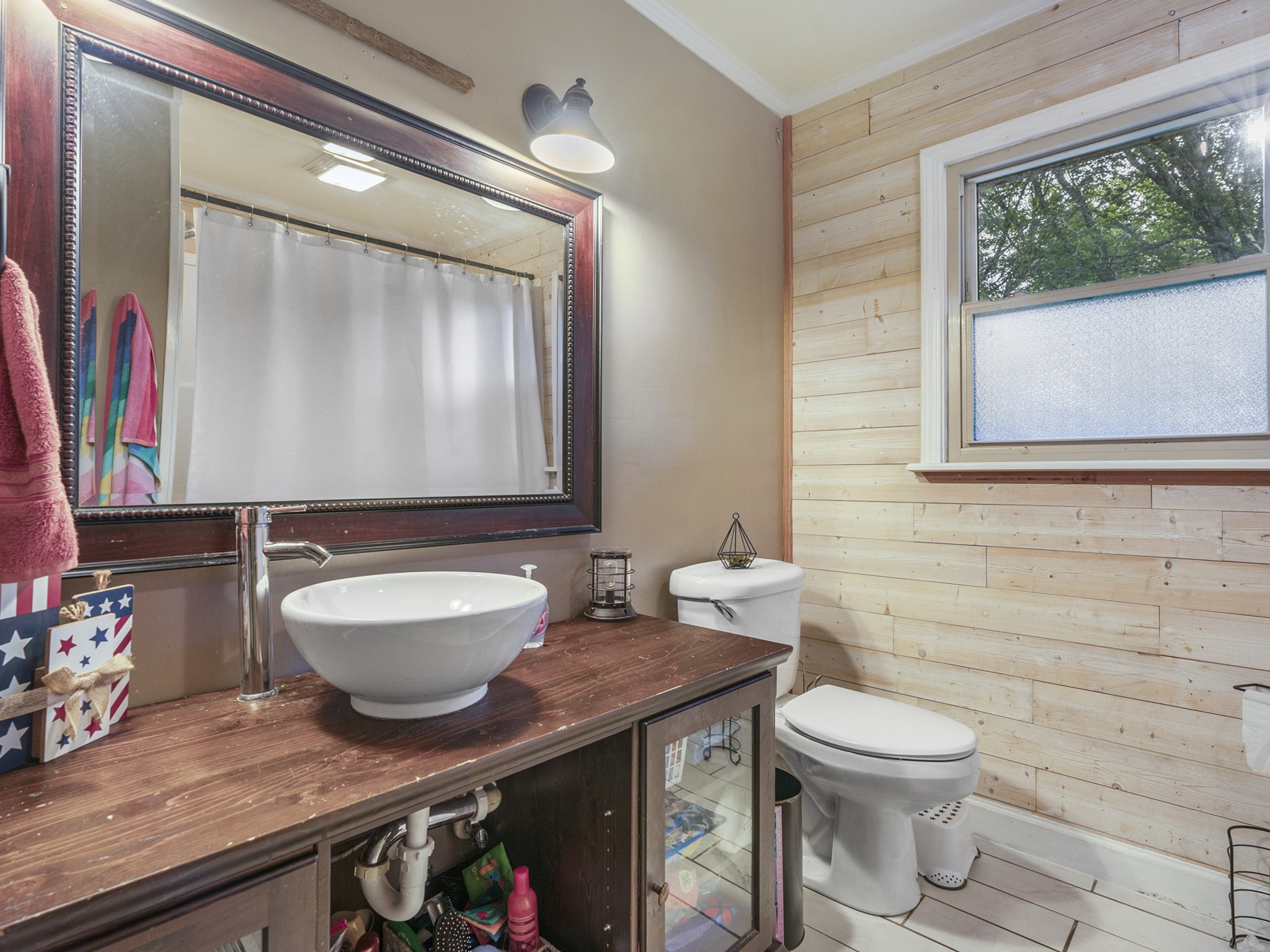 2502 Sullivan Knowles Road Sparta, TN 38583 - Photo 14 of 45 a bathroom with a granite countertop toilet sink and mirror