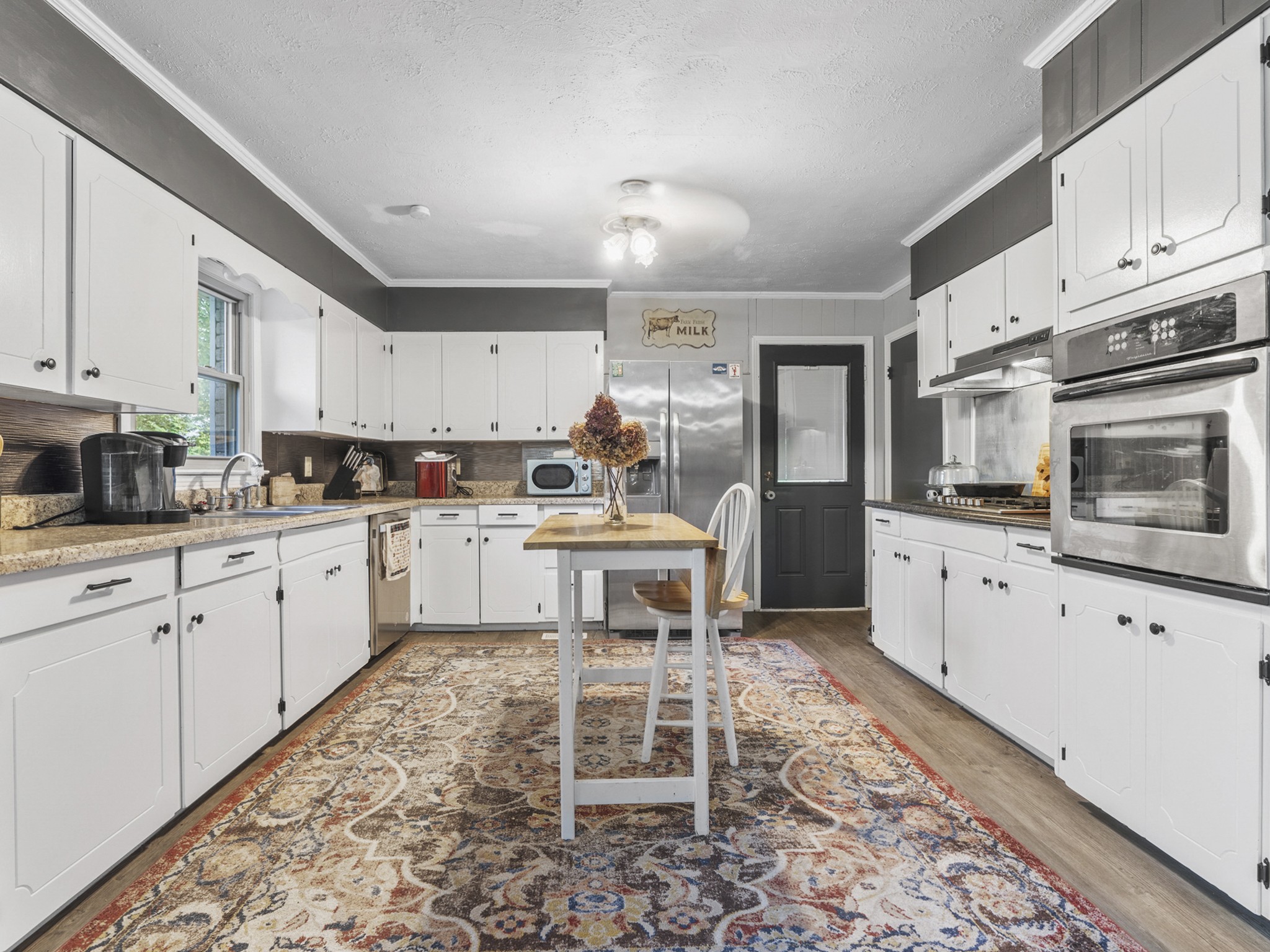 2502 Sullivan Knowles Road Sparta, TN 38583 - Photo 6 of 45 a kitchen with stainless steel appliances kitchen island granite countertop a stove a sink and a microwave