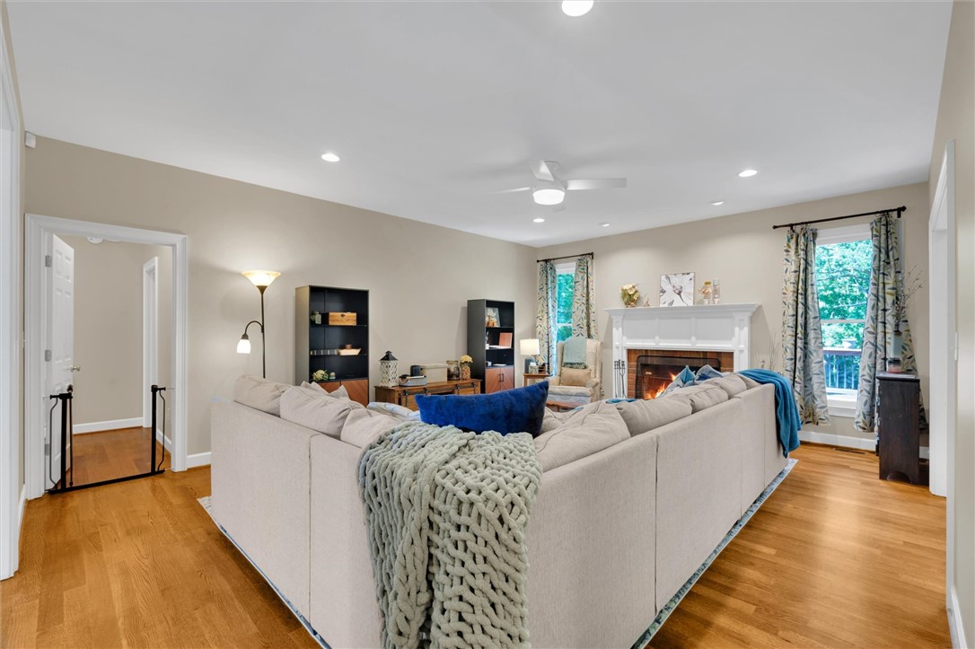 117 Winding Creek Road Anderson, SC 29621 - Photo 6 of 42 This living area features a warm fireplace and ample natural light, creating an inviting atmosphere.