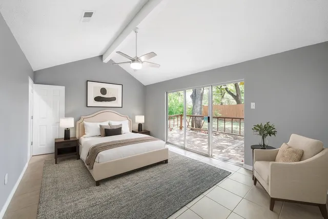 a spacious bedroom with a bed and a couch