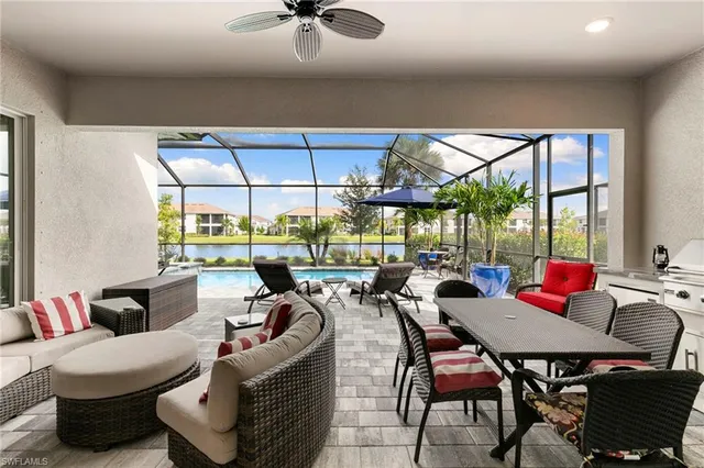 a living room with furniture a rug and a floor to ceiling window