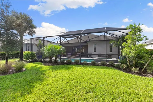 an aerial view of a house with a swimming pool and outdoor seating