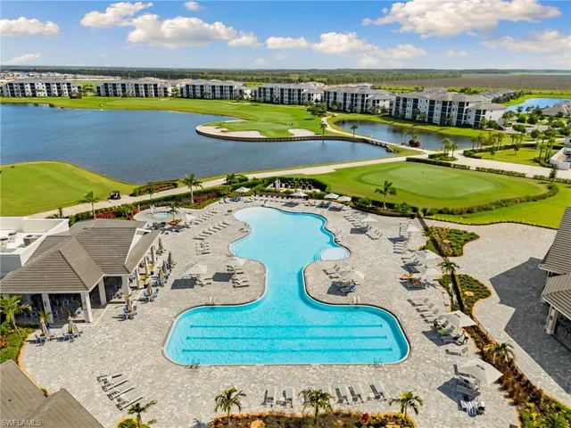 a view of swimming pool with outdoor seating and city view