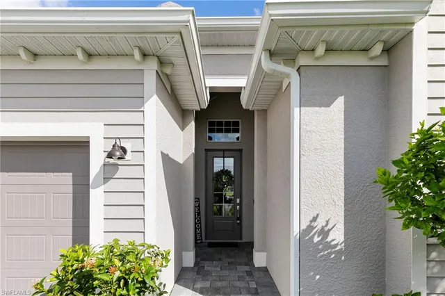 a front view of a house with a yard and a garage