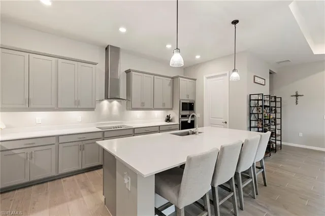 a kitchen with granite countertop white cabinets and stainless steel appliances