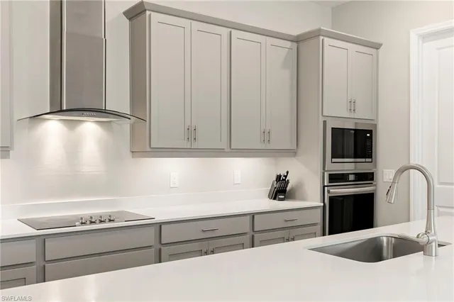 a large kitchen with kitchen island a sink dining table and chairs