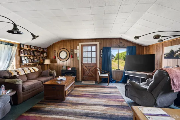 a view of a field with trees in the background