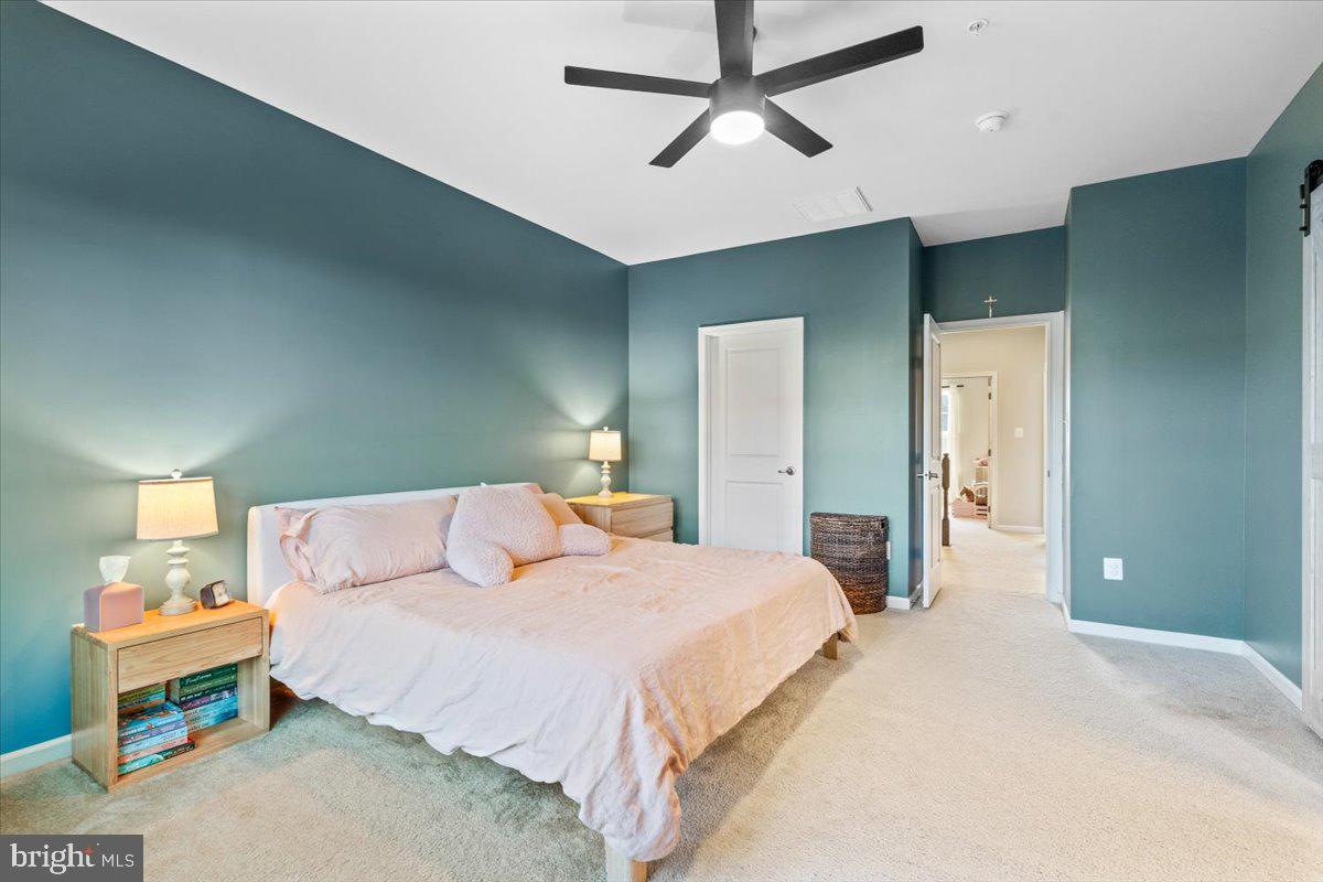 4535 Tinder Monrovia, MD 21770 - Photo 23 of 61 a bedroom with a bed and a chandelier