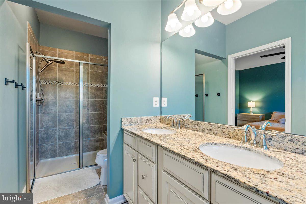 4535 Tinder Monrovia, MD 21770 - Photo 25 of 61 a bathroom with a granite countertop sink a mirror and shower