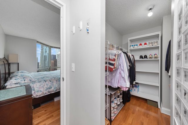 a view of walk in closet with clothes and shoes