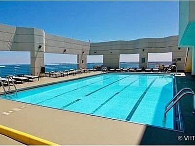 a view of a kitchen with stainless steel appliances a sink and a stove