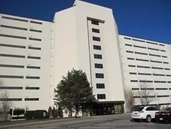 a front view of a building with parking space