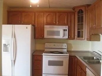 a kitchen with a refrigerator stove and sink