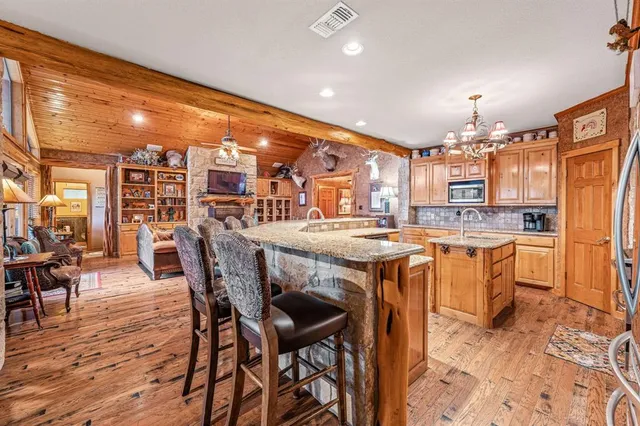 a large kitchen with a table and chairs