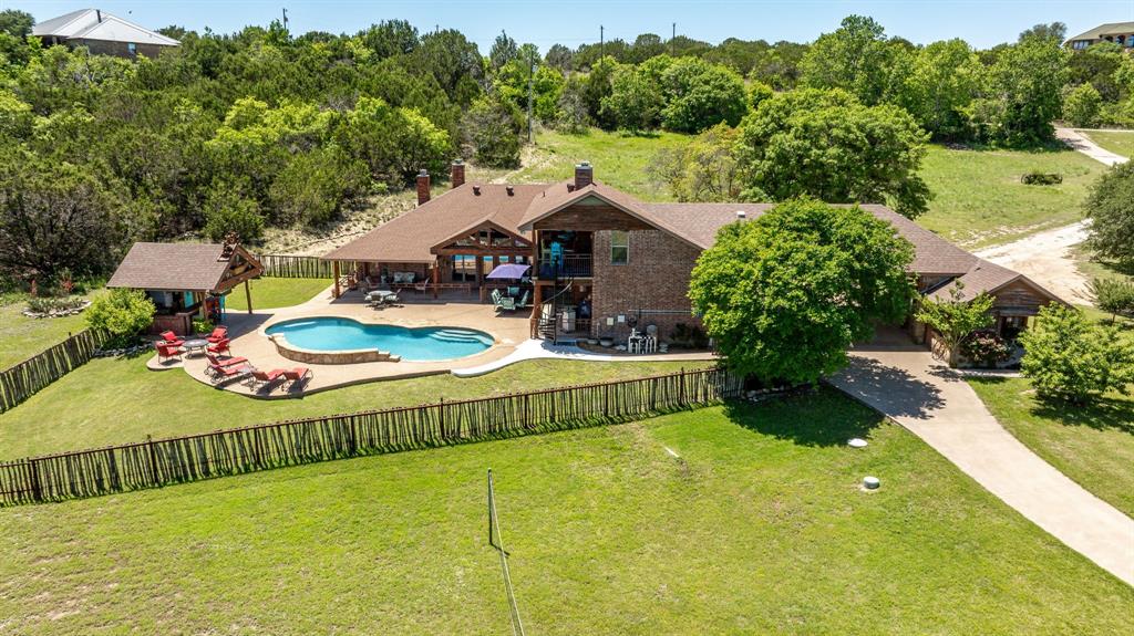 475 Magic Valley Bluff Dale, TX 76433 - Photo 2 of 40 a view of a swimming pool with a patio and a garden