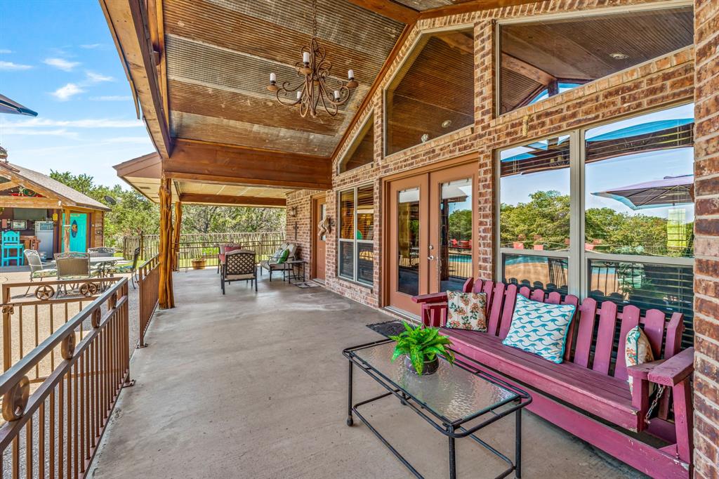 475 Magic Valley Bluff Dale, TX 76433 - Photo 29 of 40 a balcony with furniture and a lot of potted plants